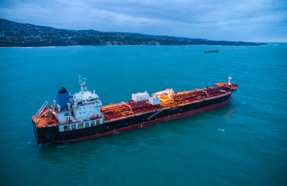 Aerial view oil ship tanker carrier oil on the sea at sunrise Aerial top view oil ship tanker carrier oil on the sea at sunrise